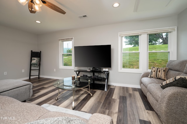 living room featuring ceiling fan, wood-type flooring, and a healthy amount of sunlight