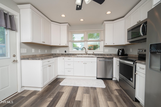 kitchen with white cabinetry, sink, ceiling fan, dark hardwood / wood-style floors, and appliances with stainless steel finishes