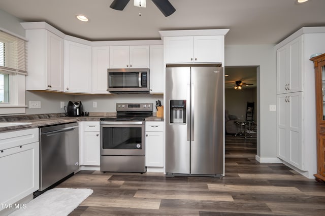 kitchen featuring white cabinets, stainless steel appliances, ceiling fan, and dark hardwood / wood-style floors