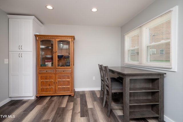 dining area featuring dark wood-type flooring