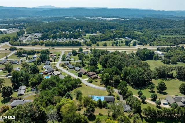 drone / aerial view with a wooded view and a mountain view