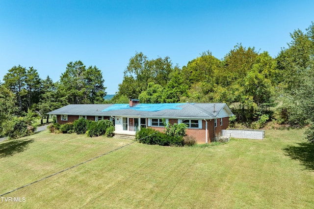 ranch-style home featuring a front yard