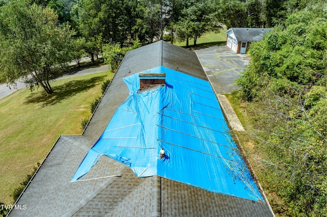 exterior space featuring a yard, an outbuilding, and a garage