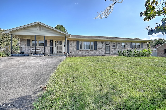 ranch-style house with a porch and a front lawn