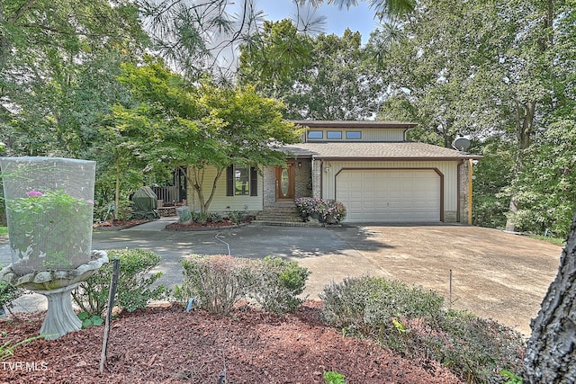 view of front facade with brick siding, an attached garage, driveway, and a shingled roof