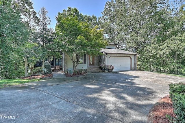 obstructed view of property with an attached garage and driveway