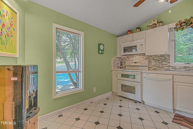 kitchen with white appliances, lofted ceiling, ceiling fan, white cabinetry, and backsplash