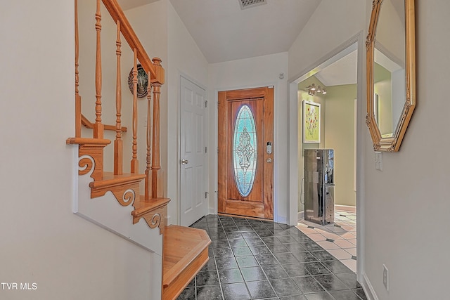 entrance foyer with stairway, baseboards, and visible vents