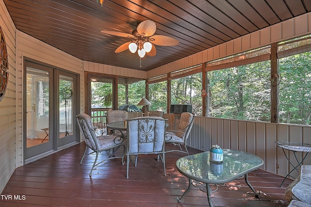 sunroom featuring wooden ceiling and a ceiling fan