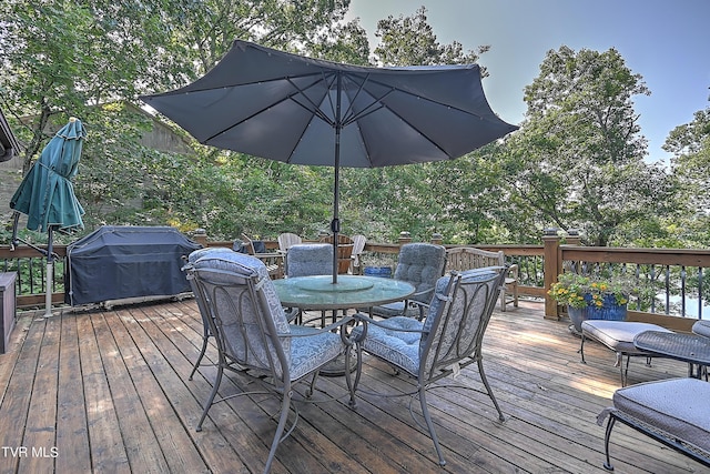 wooden terrace with a grill and outdoor dining space