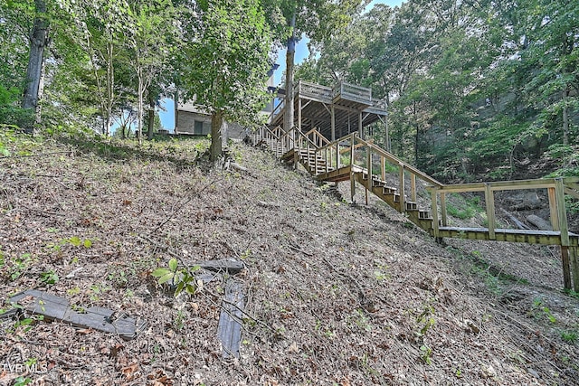 view of yard with stairway and a deck