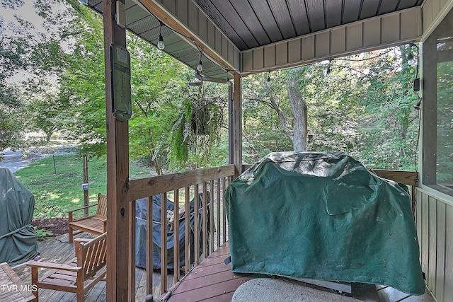 wooden terrace with a grill