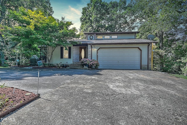 view of front of house featuring concrete driveway and an attached garage