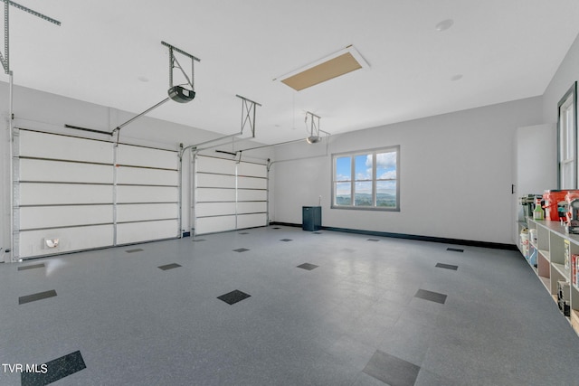 garage with a garage door opener and baseboards