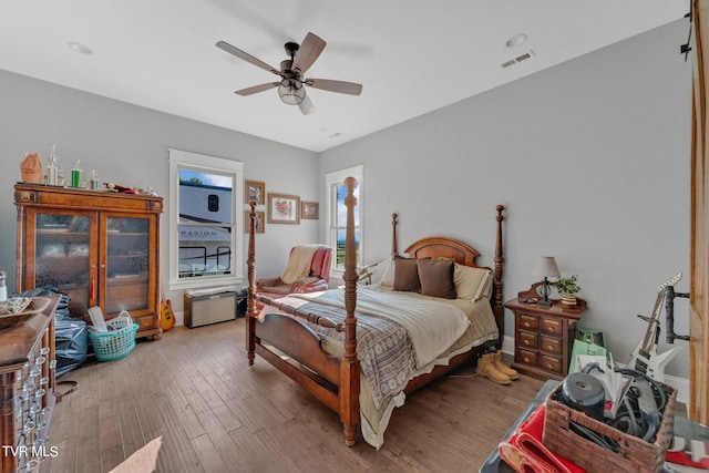 bedroom featuring visible vents, light wood finished floors, and ceiling fan