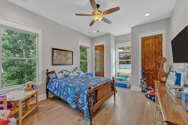 bedroom with ceiling fan and light hardwood / wood-style floors