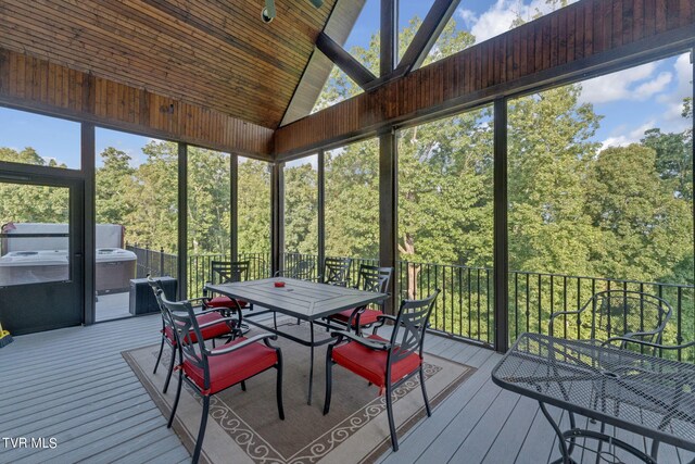 sunroom / solarium featuring lofted ceiling and wooden ceiling