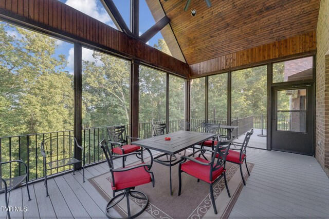 unfurnished sunroom with lofted ceiling, wood ceiling, and ceiling fan