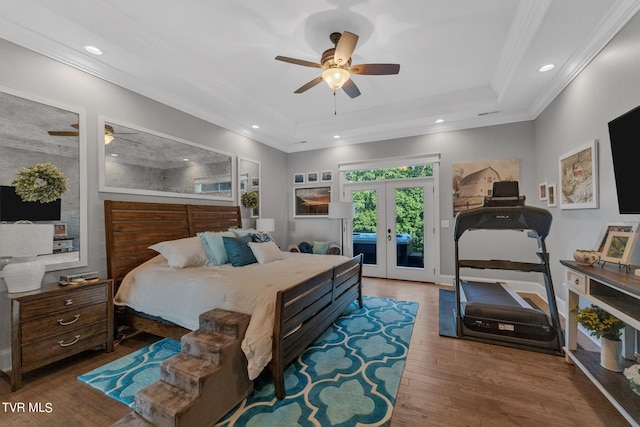 bedroom with access to exterior, hardwood / wood-style flooring, crown molding, and a raised ceiling