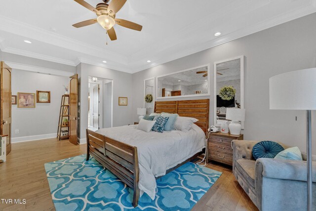 bedroom featuring crown molding, ceiling fan, and light hardwood / wood-style floors