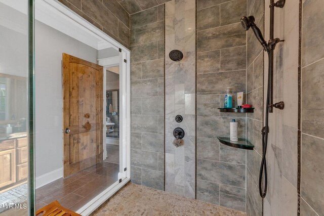 bathroom with a shower with door