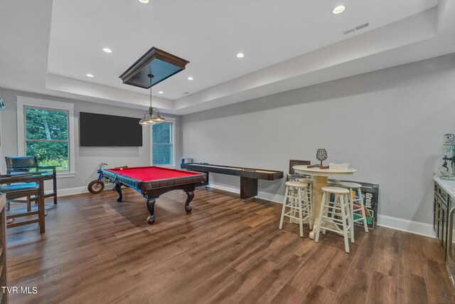 rec room with dark wood-type flooring, a tray ceiling, and billiards