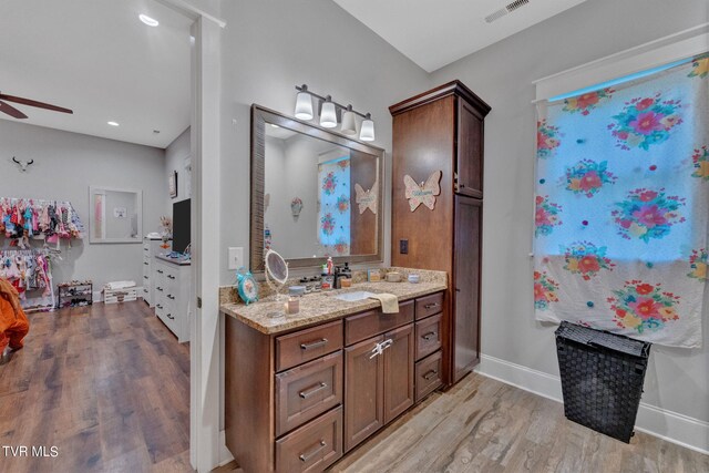 bathroom with vanity, hardwood / wood-style floors, and ceiling fan