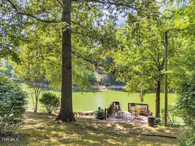 exterior space featuring a water view and a patio area