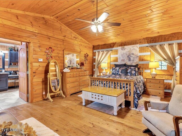 bedroom with light wood-type flooring, vaulted ceiling, wooden walls, and wood ceiling