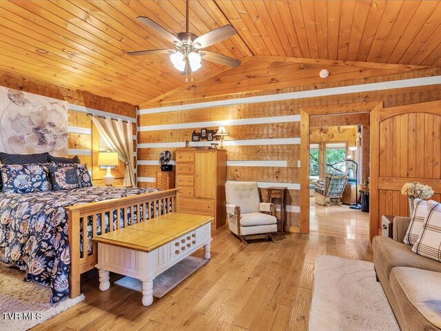 bedroom featuring lofted ceiling, wood walls, wooden ceiling, and light hardwood / wood-style floors