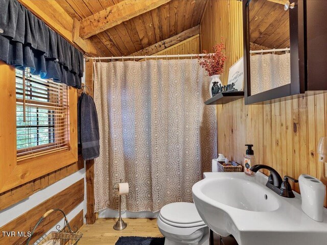 bathroom with hardwood / wood-style floors, toilet, wooden walls, and wooden ceiling