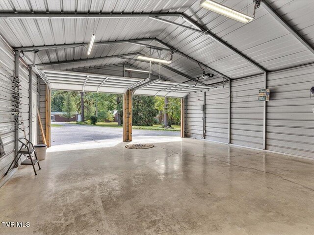 garage with a garage door opener and a carport