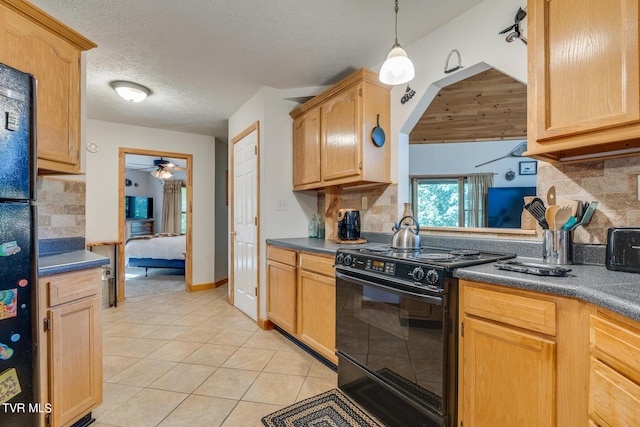 kitchen featuring dark countertops, black appliances, light tile patterned floors, and backsplash