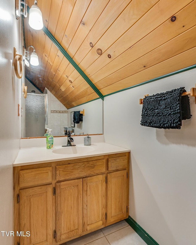 bathroom featuring wooden ceiling, vanity, baseboards, vaulted ceiling, and tile patterned floors