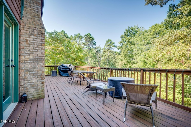 wooden terrace featuring outdoor dining area