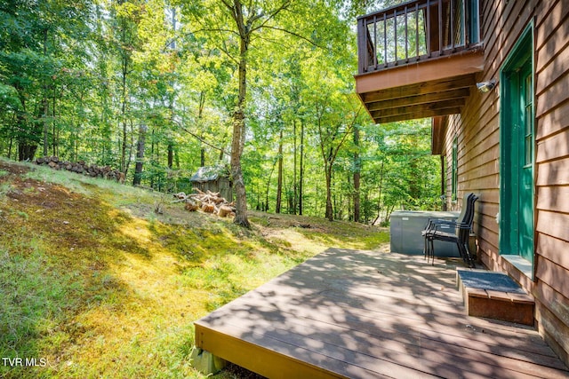 wooden terrace with a wooded view