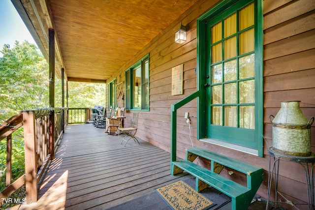 wooden terrace with a porch