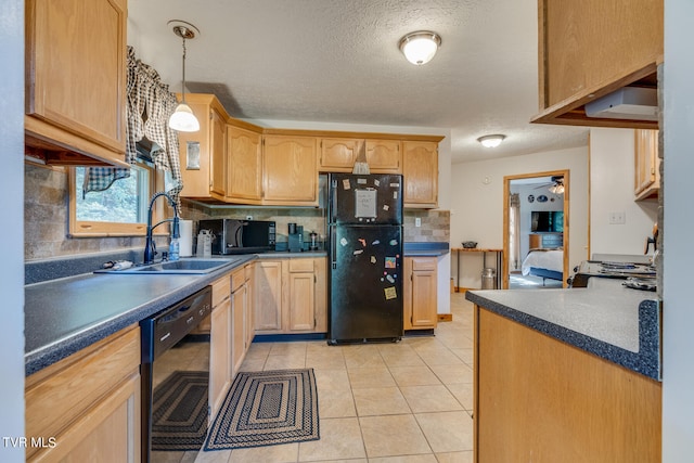 kitchen featuring sink, decorative light fixtures, decorative backsplash, light tile patterned floors, and black appliances