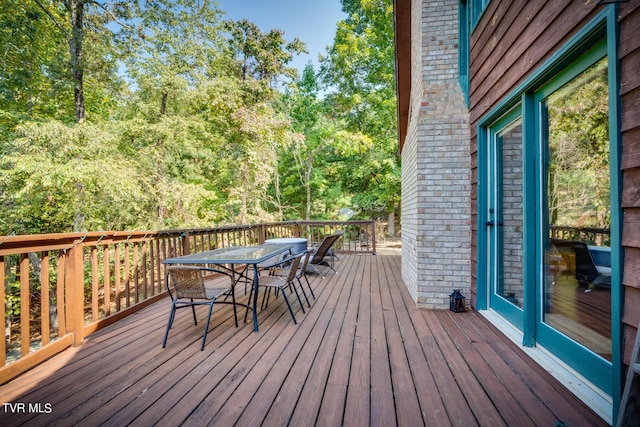 wooden terrace with outdoor dining area