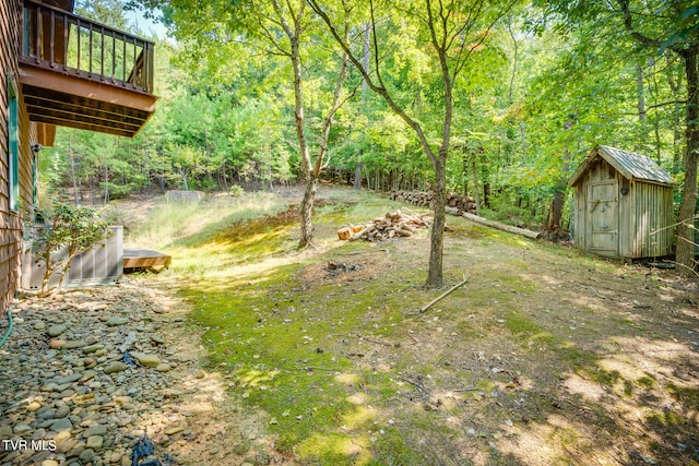 view of yard with a wooden deck and a shed