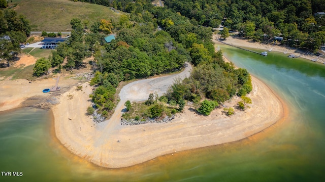 aerial view with a water view and a beach view