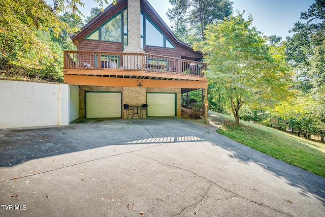 view of side of property with a deck and a garage