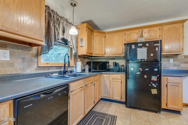 kitchen featuring light tile patterned floors, dark countertops, a textured ceiling, black appliances, and a sink