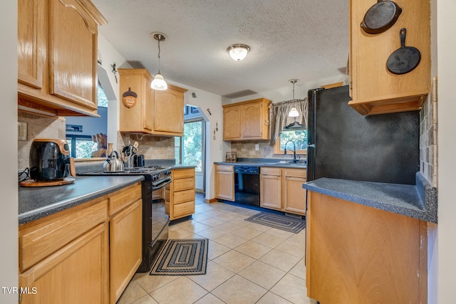 kitchen featuring hanging light fixtures, plenty of natural light, light tile patterned floors, and black appliances