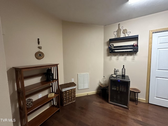 bar with dark hardwood / wood-style flooring