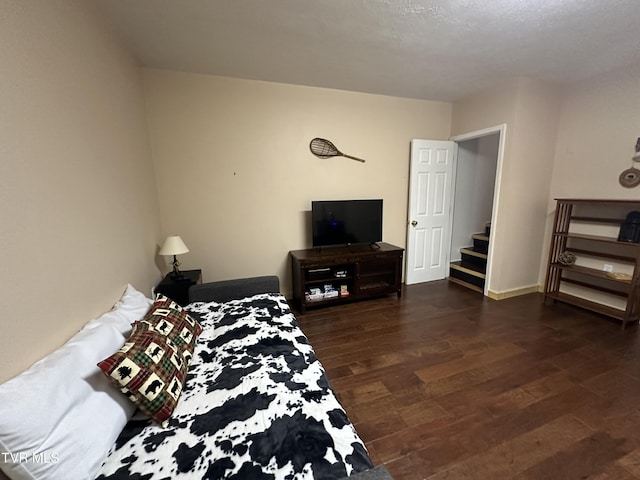 bedroom with dark hardwood / wood-style flooring