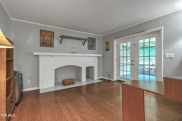 unfurnished living room featuring a fireplace, dark hardwood / wood-style flooring, crown molding, and a textured ceiling