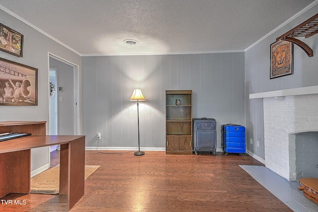 unfurnished office with hardwood / wood-style flooring, crown molding, and a textured ceiling