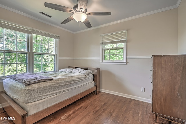 bedroom featuring crown molding, dark wood-type flooring, ceiling fan, and multiple windows