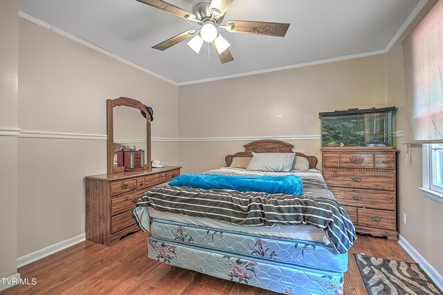 bedroom with crown molding, ceiling fan, and hardwood / wood-style floors